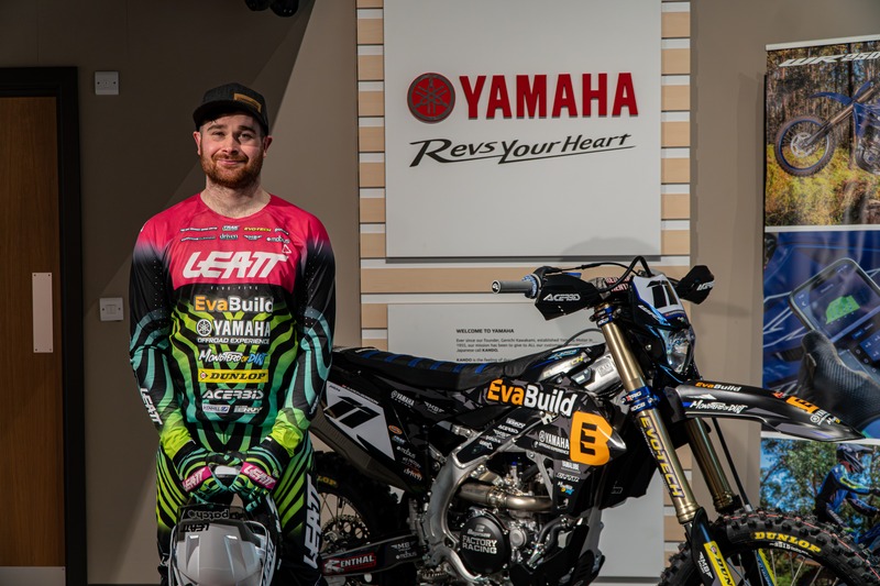 Rider portrait beside a Yamaha motorcycle